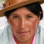 a woman wearing a brown hat and a pink shirt