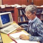 woman sitting at desk with desktop computer